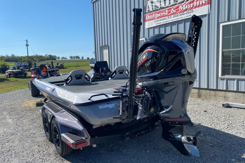 Slide: The Image of 2026 Skeeter FXR21 FLEX boat with Yamaha engine, parked outside marine shop. - 7