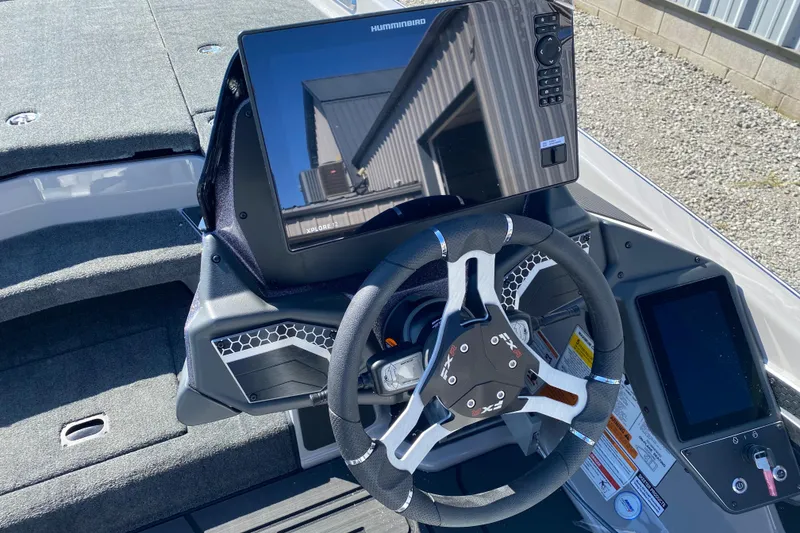 Slide: The Image of 2026 Skeeter FXR21 FLEX boat dashboard with steering wheel and electronic display. - 8