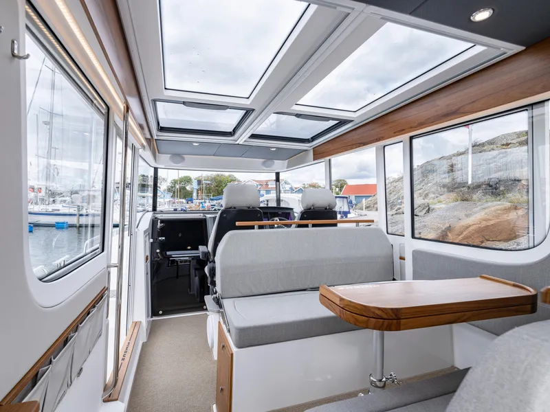 Slide: The Image of Interior of 2026 Nimbus Commuter 11 boat with modern seating and panoramic windows. - 19