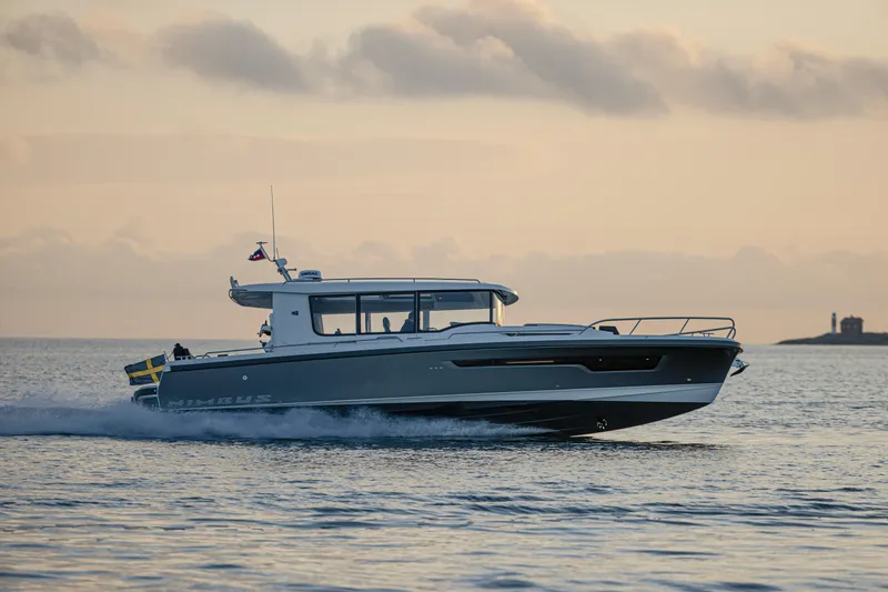 Slide: The Image of Nimbus Commuter 11 boat cruising at sunset, 2026 model, on open water. - 3