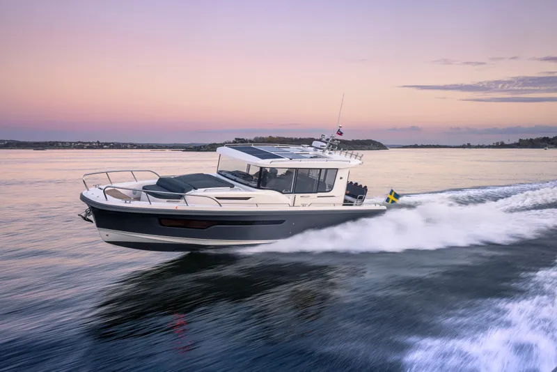 Slide: The Image of Nimbus Commuter 11 boat cruising at sunset, 2026 model, on calm waters. - 34