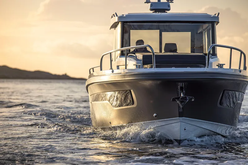 Slide: The Image of 2026 Nimbus Commuter 11 boat cruising at sunset on open water. - 35