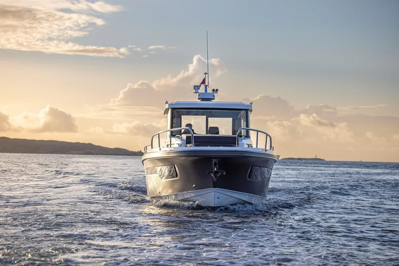 Slide: The Image of Nimbus Commuter 11 boat cruising at sunset, 2026 model, on open water. - 36