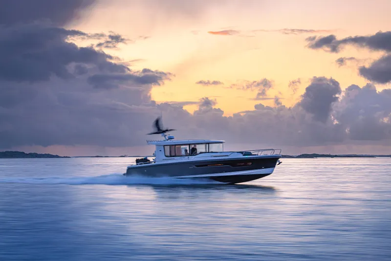 Slide: The Image of Nimbus Commuter 11 boat cruising at sunset, 2026 model, serene ocean view. - 39