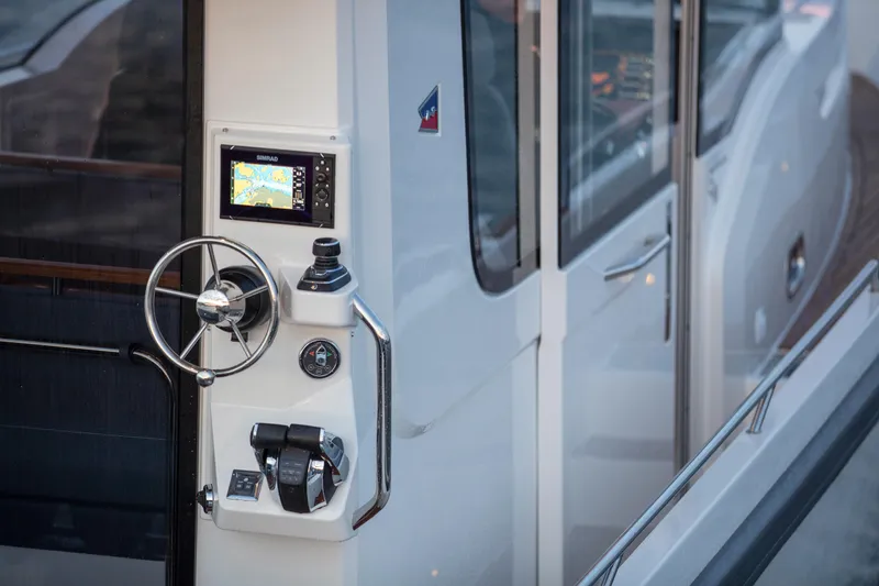 Slide: The Image of 2026 Nimbus Commuter 11 boat helm with navigation controls and sleek design. - 42