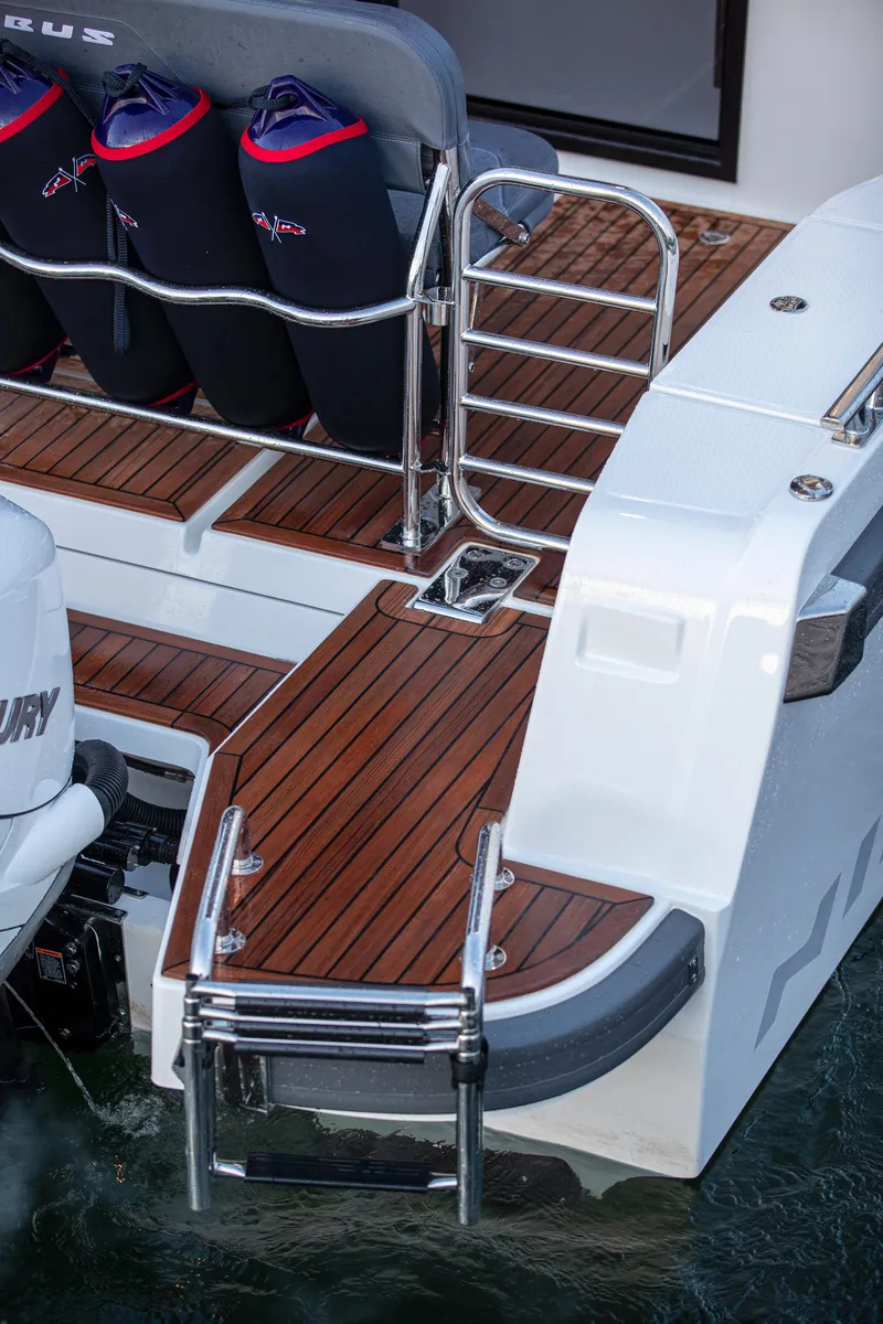 Slide: The Image of 2026 Nimbus Commuter 11 boat with teak deck and stainless steel ladder. - 43