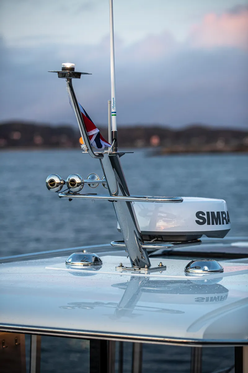 Slide: The Image of Nimbus Commuter 11 (2026) boat with radar and flag on calm water. - 44