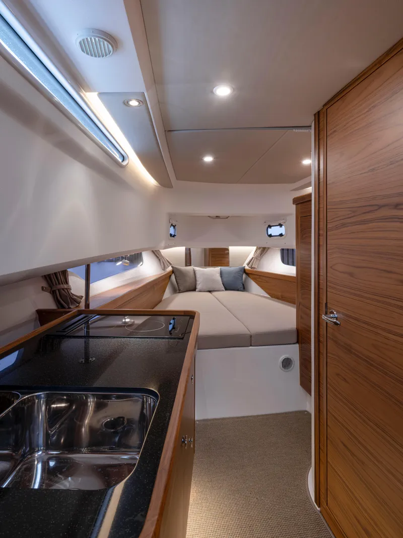 Slide: The Image of Luxurious interior of 2026 Nimbus Commuter 11 boat with modern kitchen and cozy sleeping area. - 45