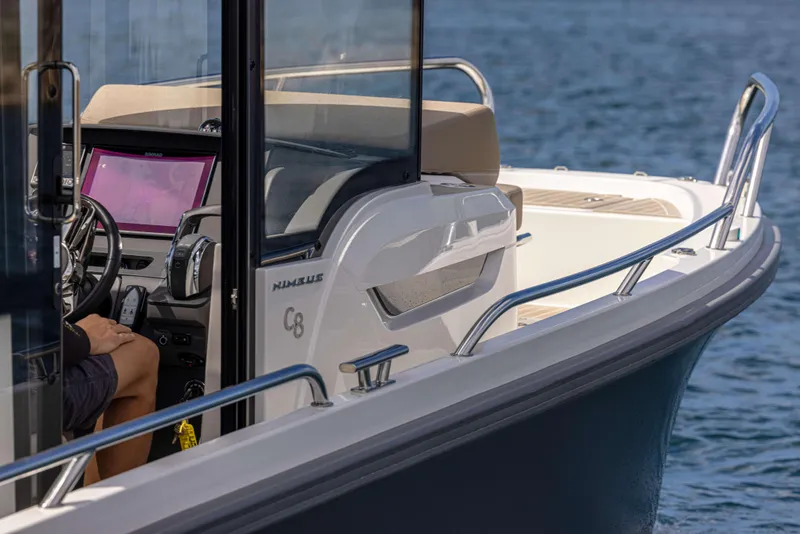 Slide: The Image of 2025 Nimbus Commuter 8 boat on water, featuring sleek design and modern controls. - 11