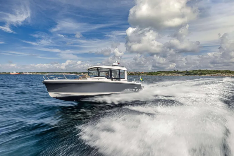 Slide: The Image of Nimbus Commuter 8 (2025) boat cruising swiftly on open water under a cloudy sky. - 16
