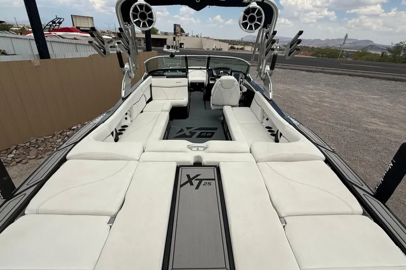 Slide: The Image of 2018 MasterCraft XT25 boat interior with white seating and modern design. - 12