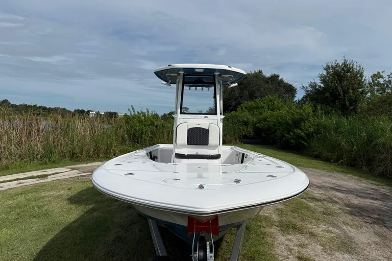 Slide: The Image of 2026 Tidewater 2410 Bay Max boat on grassy terrain, showcasing sleek design and modern features. - 10