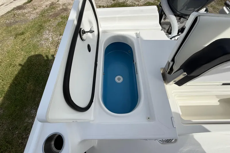 Slide: The Image of 2026 Tidewater 2410 Bay Max boat with open storage compartment and seating. - 24