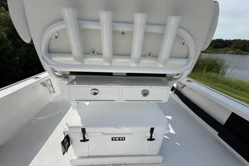 Slide: The Image of 2026 Tidewater 2410 Bay Max boat interior with rod holders and Yeti cooler. - 27
