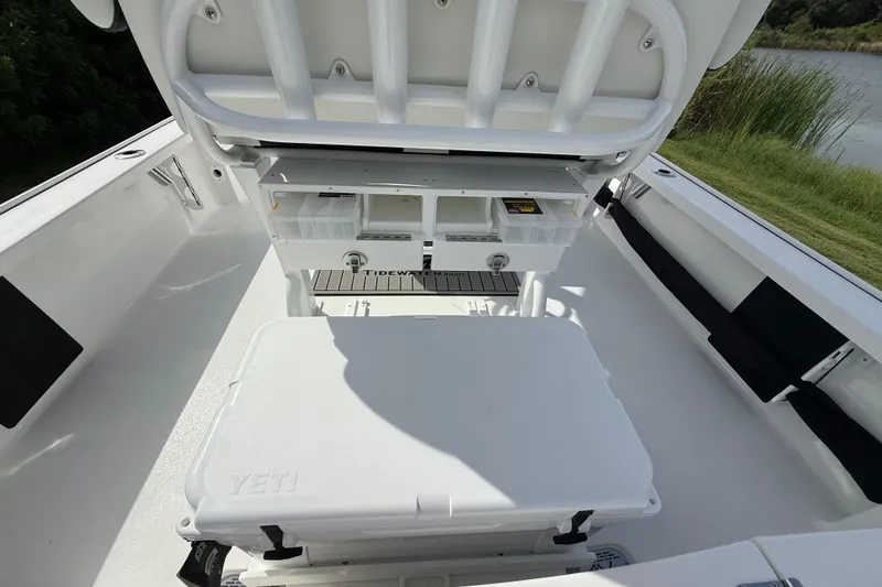 Slide: The Image of 2026 Tidewater 2410 Bay Max boat interior with storage compartments and Yeti cooler. - 28