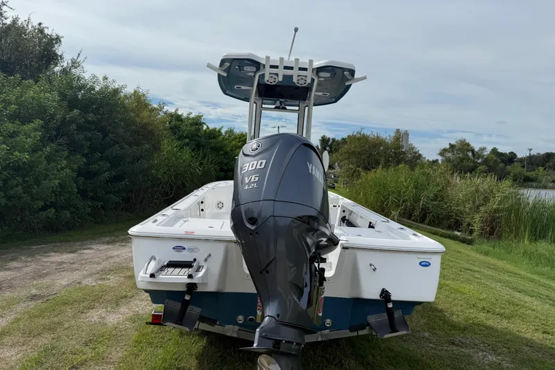 Slide: The Image of 2026 Tidewater 2410 Bay Max boat with Yamaha 300 V6 engine, parked on grass. - 3