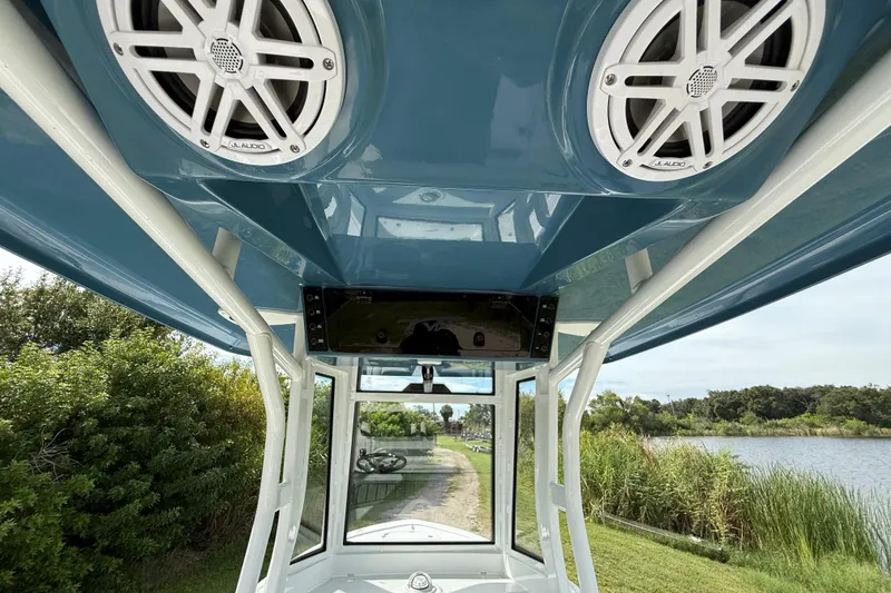 Slide: The Image of 2026 Tidewater 2410 Bay Max boat interior with speakers and scenic river view. - 30