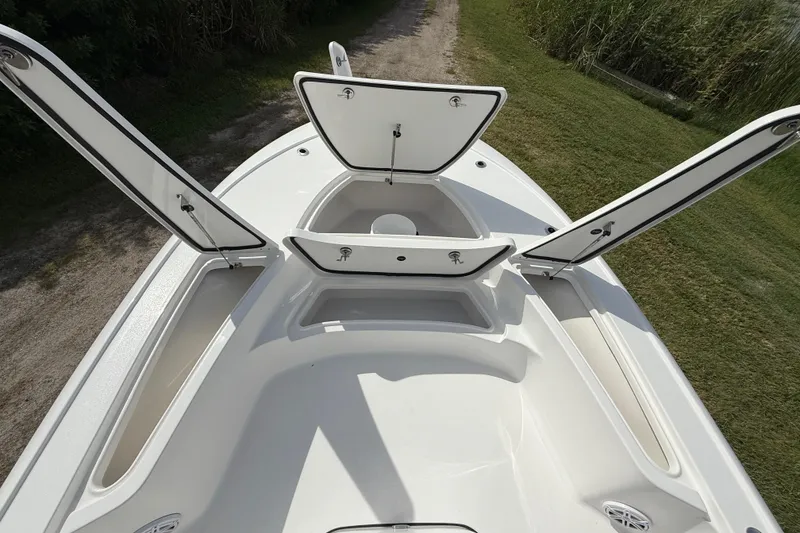 Slide: The Image of 2026 Tidewater 2410 Bay Max boat with open storage compartments on deck. - 34
