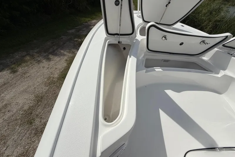 Slide: The Image of 2026 Tidewater 2410 Bay Max boat with open storage compartments on deck. - 35