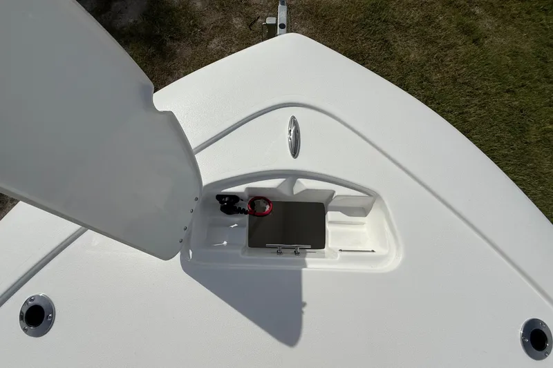 Slide: The Image of 2026 Tidewater 2410 Bay Max boat deck with open storage compartment. - 39