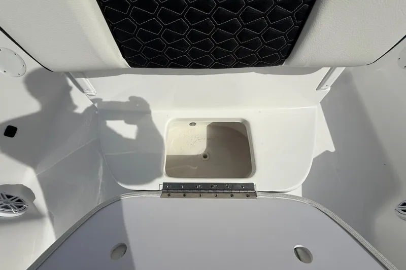 Slide: The Image of 2026 Tidewater 2410 Bay Max boat interior with storage compartment and seating. - 40