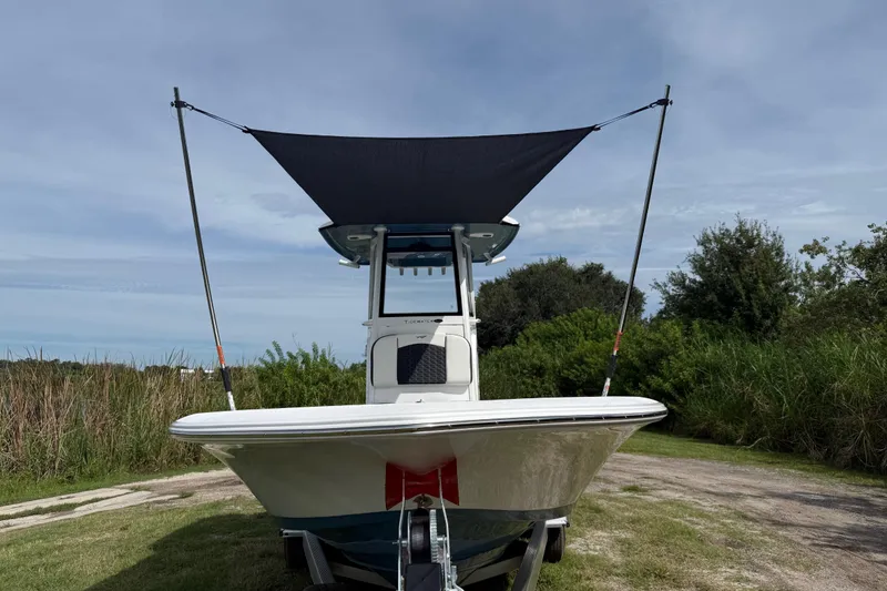 Slide: The Image of 2026 Tidewater 2410 Bay Max boat with canopy, parked on grassy area. - 43