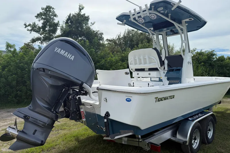 Slide: The Image of 2026 Tidewater 2410 Bay Max boat with Yamaha engine on trailer, surrounded by greenery. - 5