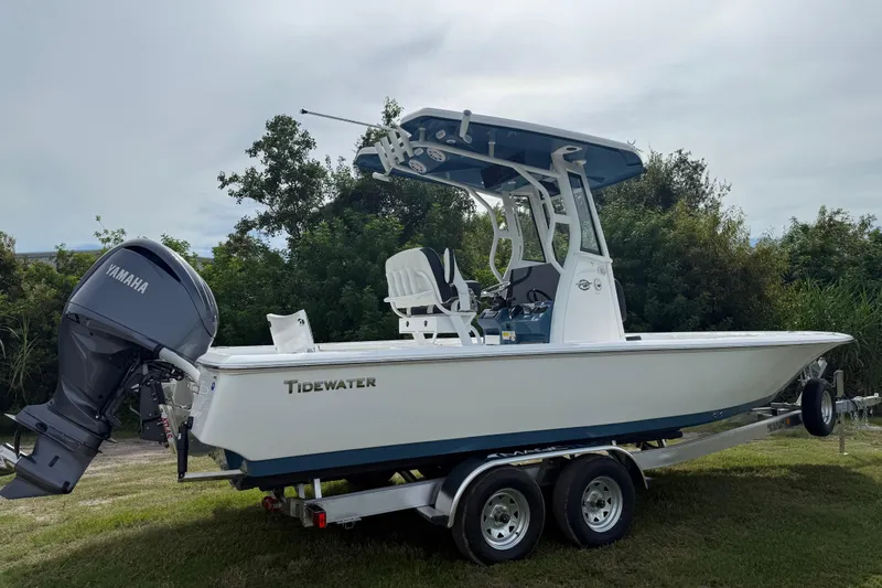 Slide: The Image of 2026 Tidewater 2410 Bay Max boat with Yamaha engine on trailer, parked outdoors. - 6