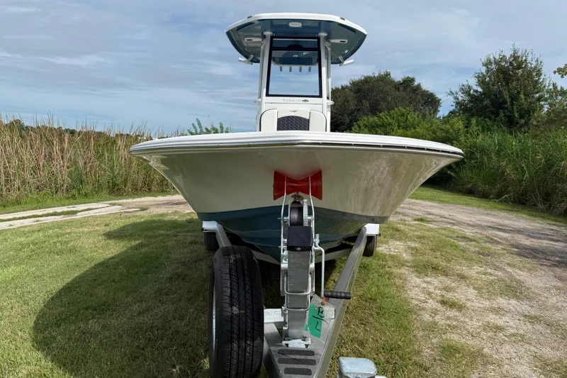 Slide: The Image of 2026 Tidewater 2410 Bay Max boat on trailer, parked on grassy area. - 9