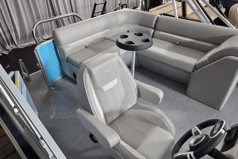 Slide: The Image of Interior of 2026 Godfrey Experience 2086 BFX pontoon boat with gray seating and steering wheel. - 6