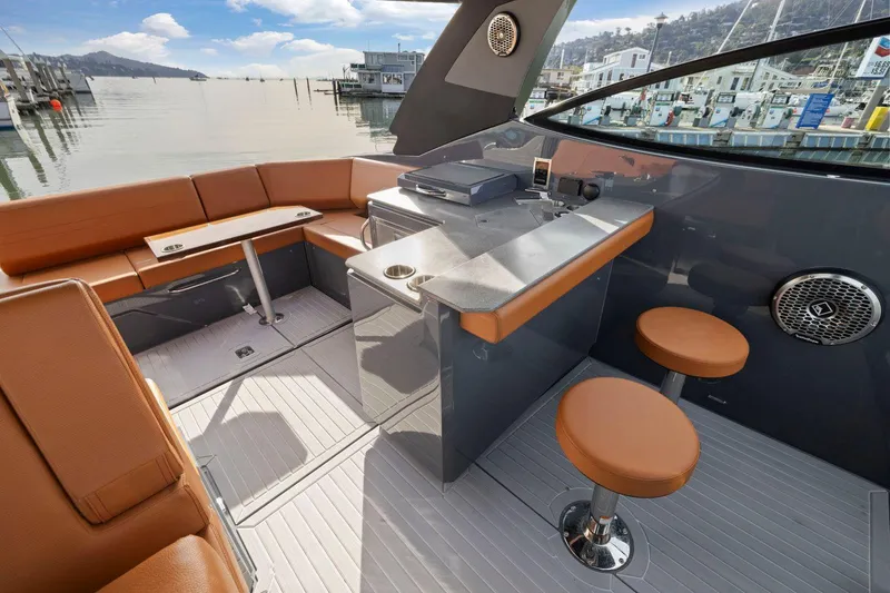 Slide: The Image of 2022 Cruisers Yachts 38 GLS South Beach IO interior with seating and bar area. - 18