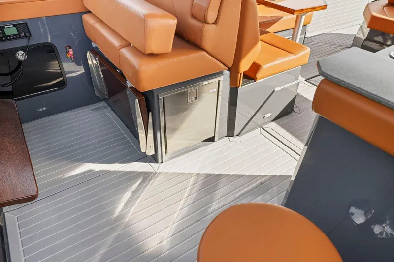 Slide: The Image of 2022 Cruisers Yachts 38 GLS South Beach IO interior with orange seating and stainless steel appliances. - 32