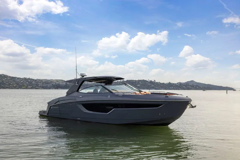 Slide: The Image of 2022 Cruisers Yachts 38 GLS South Beach IO on calm water under blue sky. - 5