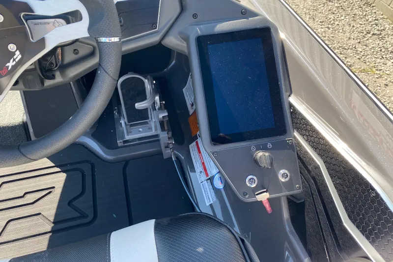 Slide: The Image of 2026 Skeeter FXR21 FLEX boat dashboard with steering wheel and touchscreen display. - 10