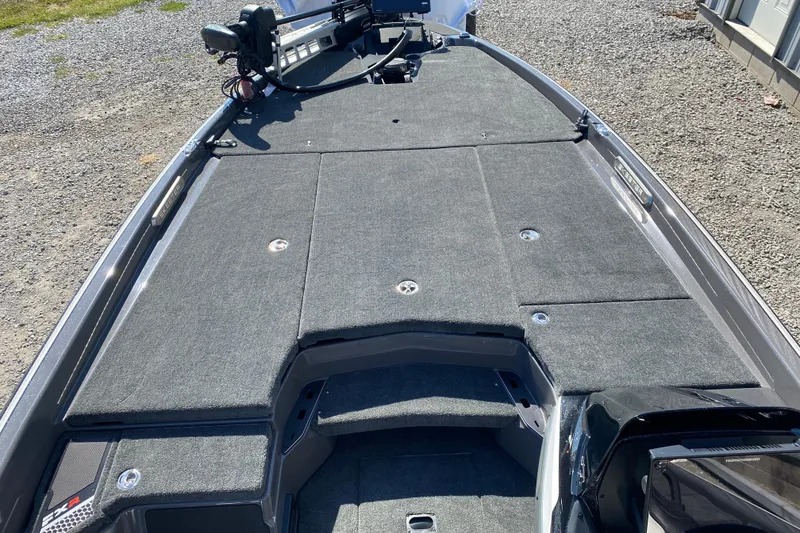 Slide: The Image of 2026 Skeeter FXR21 FLEX boat deck with carpeted surface and equipment. - 12