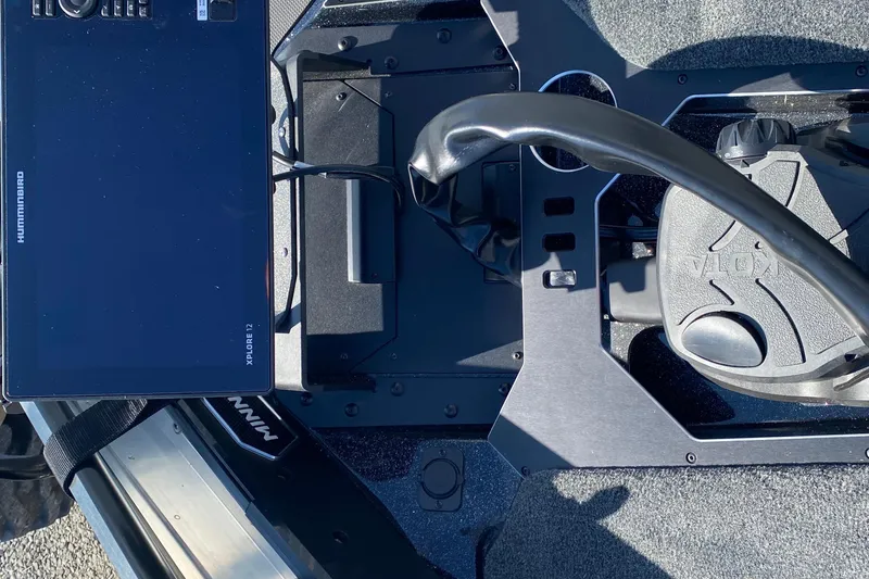 Slide: The Image of 2026 Skeeter FXR21 FLEX boat dashboard with Humminbird XPLORE 12 display and Minn Kota controls. - 13