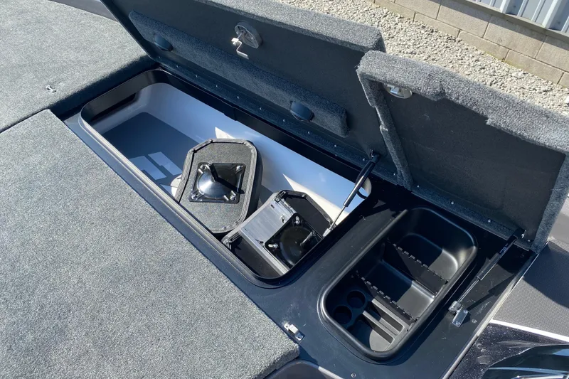 Slide: The Image of Open storage compartments on 2026 Skeeter FXR21 FLEX boat deck. - 16