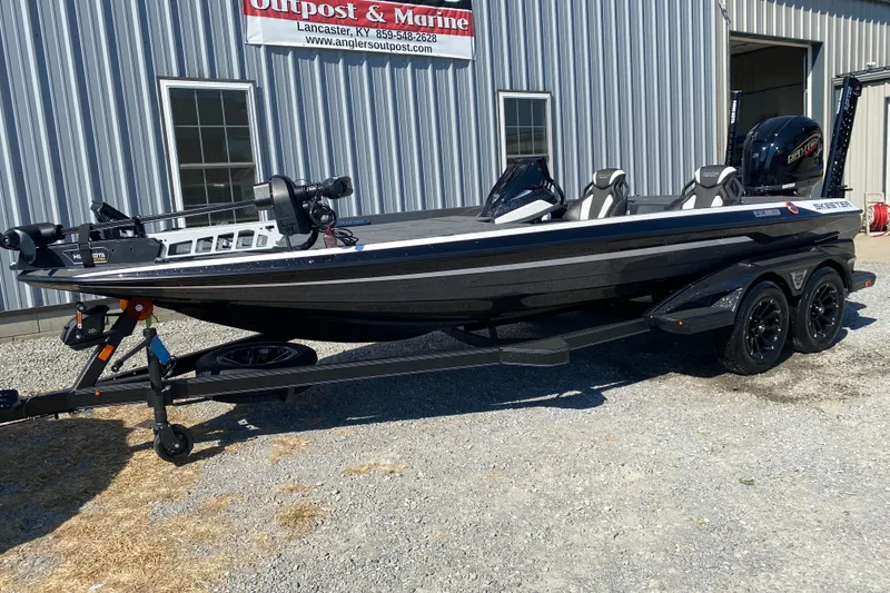 Slide: The Image of 2026 Skeeter FXR21 FLEX boat on trailer outside dealership. - 3