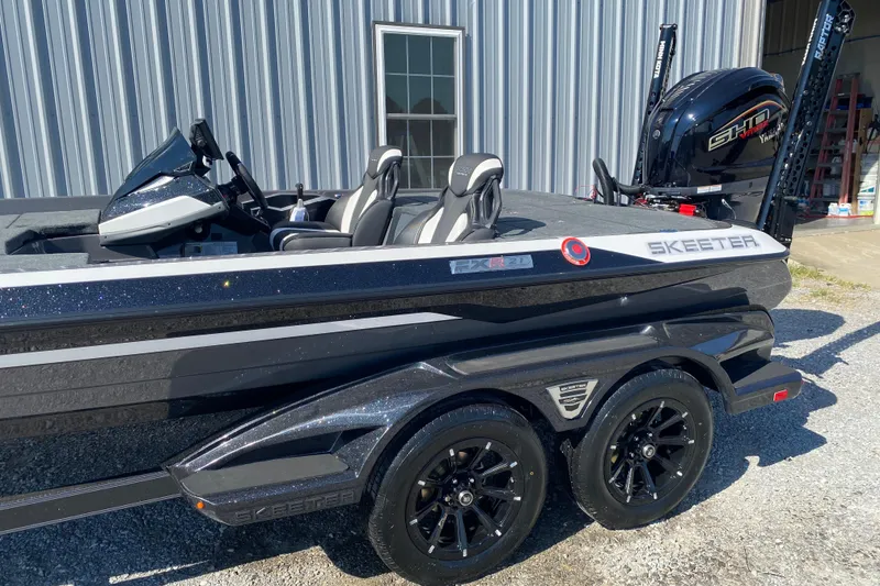 Slide: The Image of 2026 Skeeter FXR21 FLEX boat with sleek design and modern features, parked outdoors. - 6