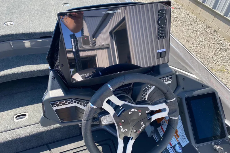 Slide: The Image of 2026 Skeeter FXR21 FLEX boat dashboard with steering wheel and electronic display. - 9