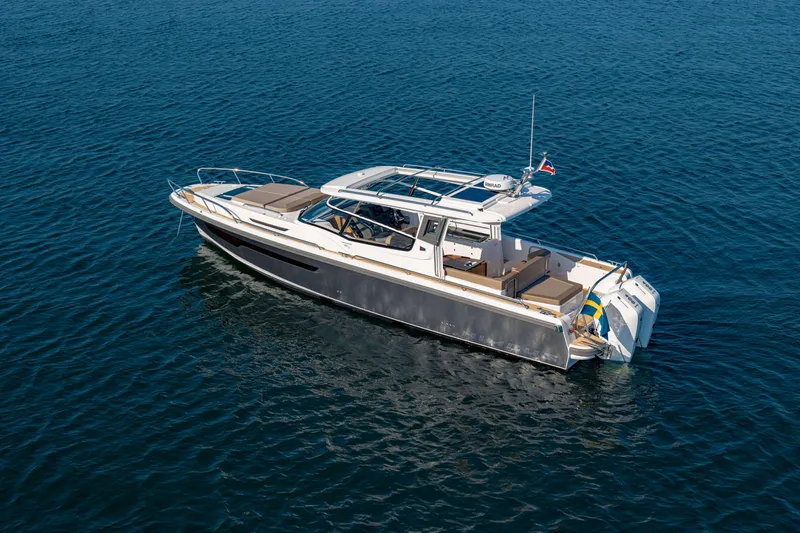 Slide: The Image of 2025 Nimbus Weekender 11 boat on calm blue water. - 35