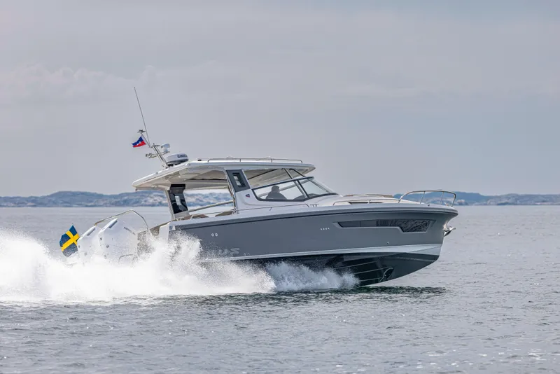 Slide: The Image of 2025 Nimbus Weekender 11 cruising on open water, showcasing sleek design and performance. - 39