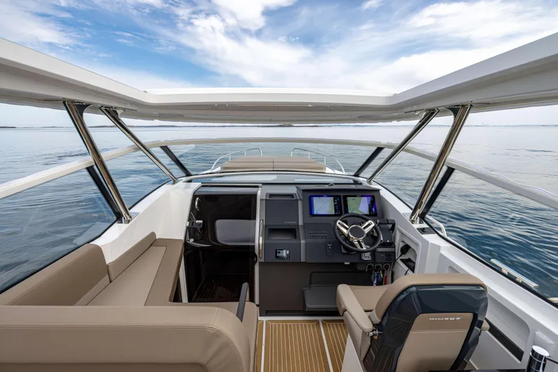 Slide: The Image of Interior view of 2025 Nimbus Weekender 11 boat, featuring modern helm and seating. - 42