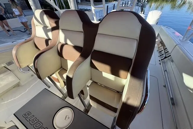 Slide: The Image of 2011 Hydra-Sports 4200 SF boat seats, brown and white leather, docked by the water. - 12