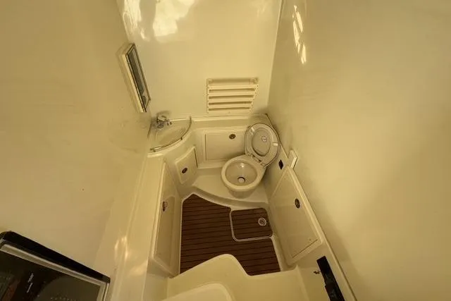 Slide: The Image of 2011 Hydra-Sports 4200 SF boat bathroom with sink, toilet, and wooden floor. - 13
