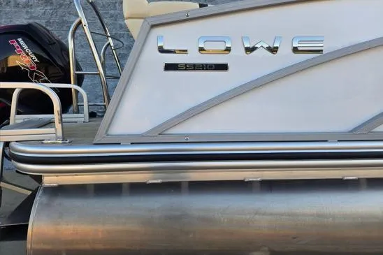 Slide: The Image of 2022 Lowe SS210 pontoon boat with Mercury outboard motor, side view. - 11
