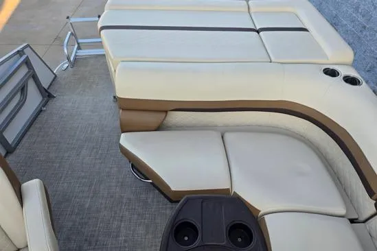 Slide: The Image of 2022 Lowe SS210 boat interior with beige seating and cup holders. - 12