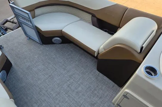 Slide: The Image of 2022 Lowe SS210 boat interior with beige and brown seating and carpeted floor. - 3