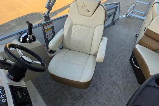Slide: The Image of Captain's chair in 2022 Lowe SS210 boat, featuring beige upholstery and modern controls. - 7
