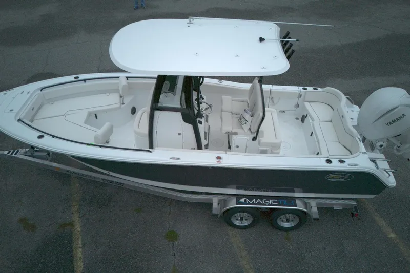 Slide: The Image of 2026 Seahunt 245 boat on trailer, featuring Yamaha engine and spacious deck layout. - 7